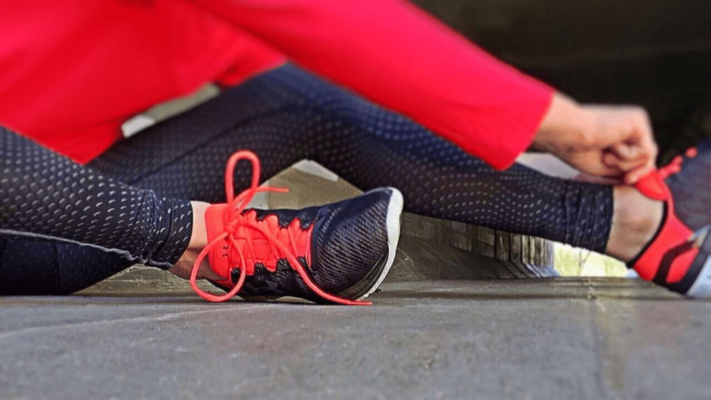 Marathon participant in training tying laces