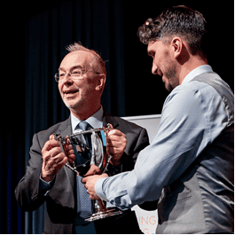 Action4Youth News - January 2024. Martin Tett receiving the cup for Buckinghamshire Council